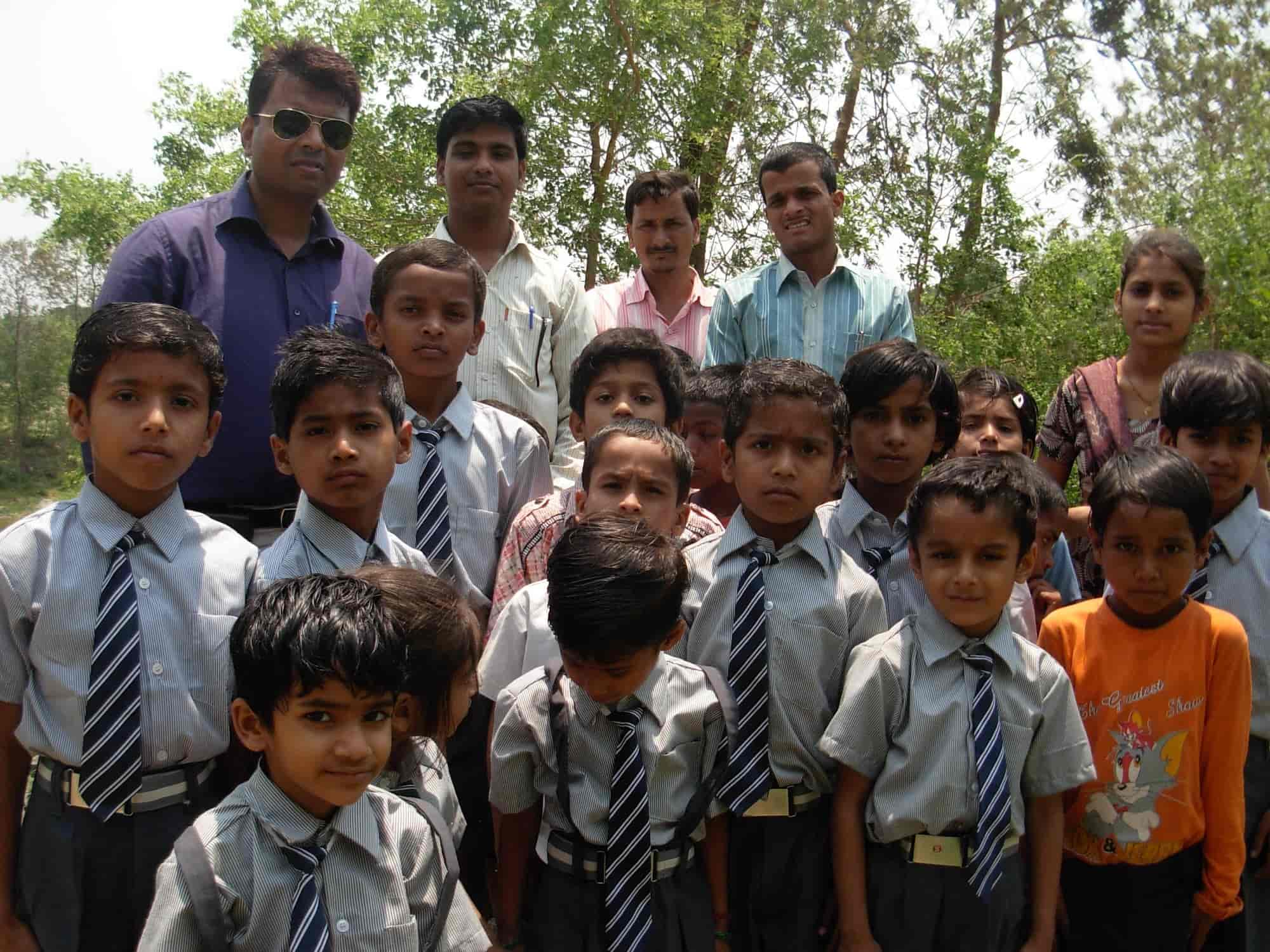 Group of school boys with teachers in front of the Trust school