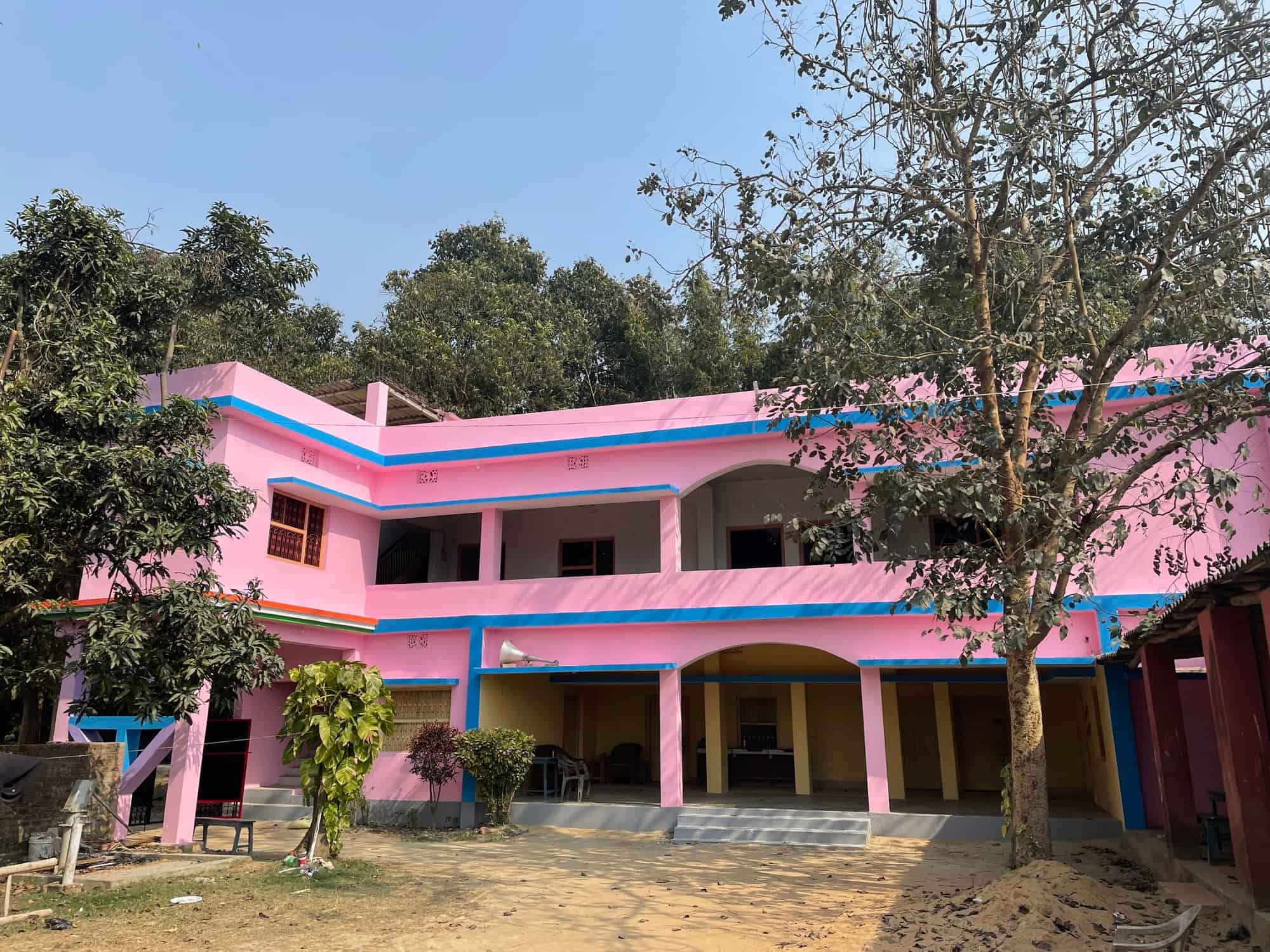 The Trust's pink two-storey building in Bishnupur, with verandahs and a courtyard